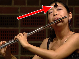 Butterfly Joins Flutist While She Performs At An International Competition.