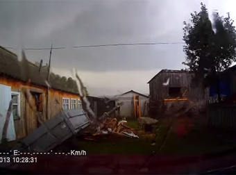 Dashcam Captures The Really Scary Moment When A Tornado Hits Right Over A Parked Car.