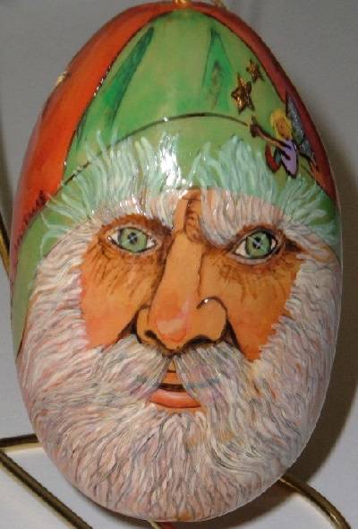 Father Christmas, wearing a green hat...on an egg?