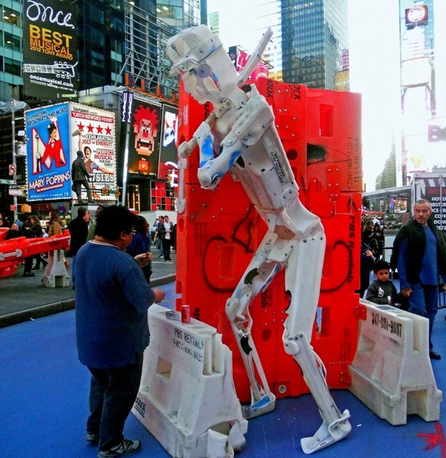 This giant plastic man is fairly interested in whatever that guy's eating.