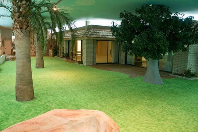 The "yard" includes a putting green, a swimming pool, two jacuzzis, a sauna, dance floor, bar and rock-camouflaged BBQ.