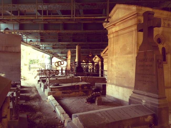 The bridge just barely clears the ornate tombs.