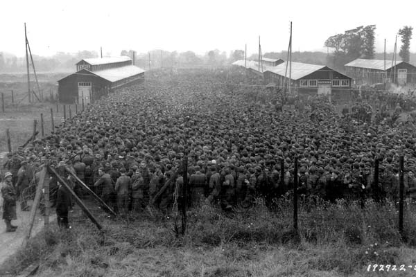 German prisoners of war captured after the D-Day landings are closely guarded by US soldiers.