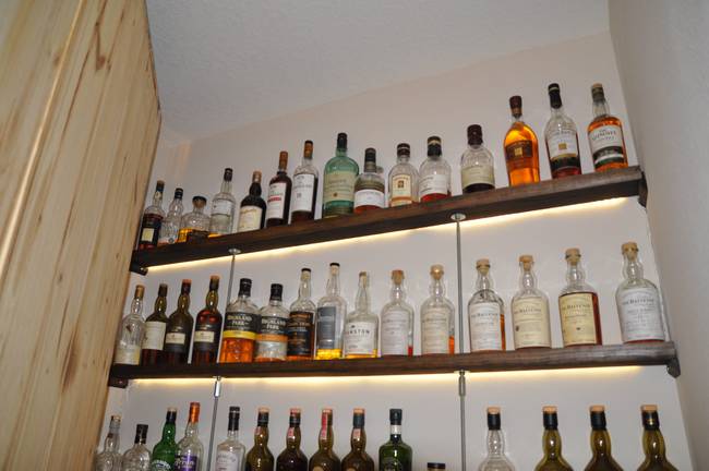 Behind his cabinet is a wonderful array of scotches, including rare single malts, lined up and ready to be poured.