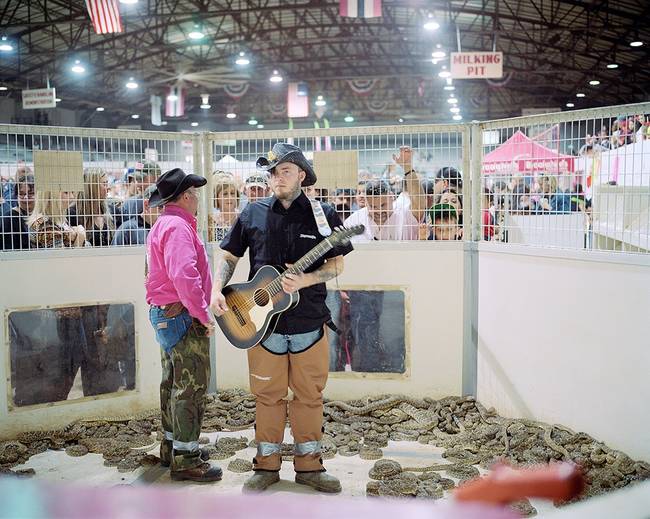 Some other performers get a bit...closer to the snakes - these two prepare to play guitar in a snake pit. No big deal.