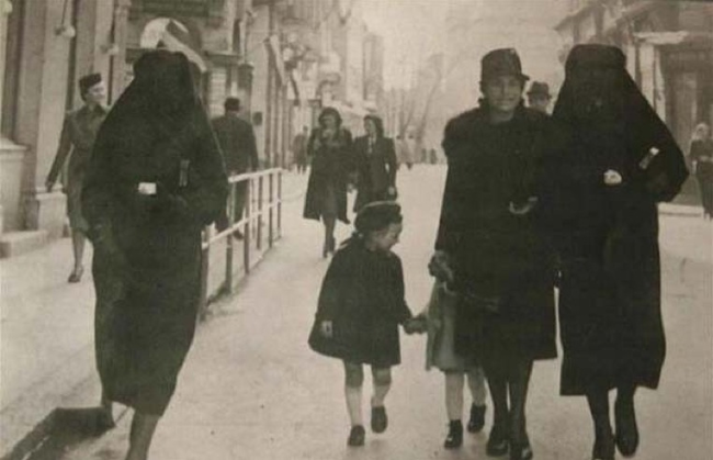 23.) Muslim woman protects a Jewish woman by covering her gold star in Sarajevo during World War II.