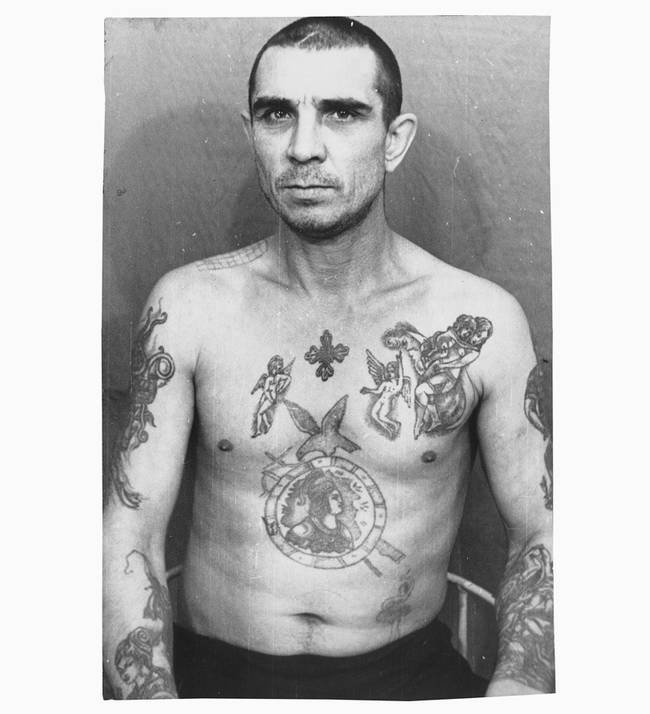 While this man's tattoos look like those of his fellow inmates (many of whom were thieves), his lack of stars (the symbol for thieves) shows that he is not a thief. He also probably holds little to no rank among the rest of the prisoners. Imitating the more powerful prisoners was popular, as it allowed them at least some measure of safety and respect.