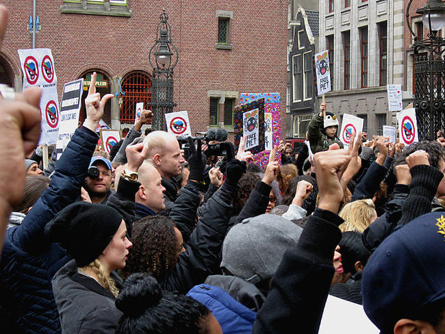 Protesters at an anti-Zwarte Piet protest in Amsterdam, November 2013. Protests against the character have happened fairly regularly in the past years, and though small, the movement is gaining recognition.