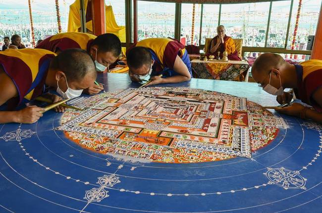 Monks constructing the Kalachakra Sand Mandala (one of the most complicated Mandala designs) as the Dalai Lama watches on.