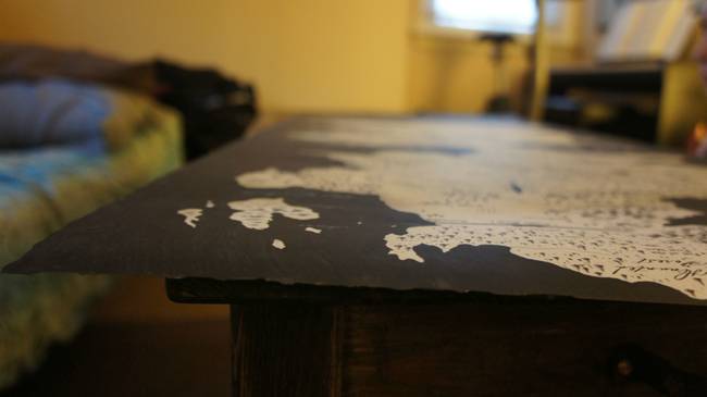 A highly detailed map of Westeros was printed out and laid across the table. The edges of the paper map were then slightly burnt to give it an old look.