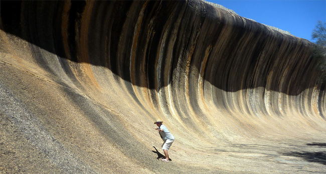 Judge, if you must, but maybe YOU should try standing next to a giant wave without going for the obvious "surfing" pose. It can't be easy.