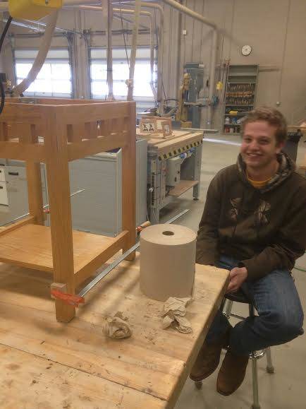 Here's the builder's friend, lending a helping hand as they reconstructed the tabletop and reinforced the base so that it was sturdier.