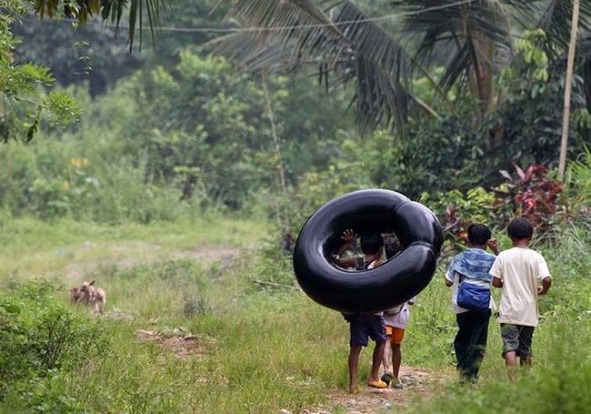 6.) Rizal Province, Philippines - Crossing the river on inflated tire tubes is the best way to get to school around here.