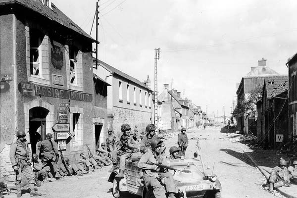 US Army paratroopers of the 101st Airborne Division drive a captured German vehicle.