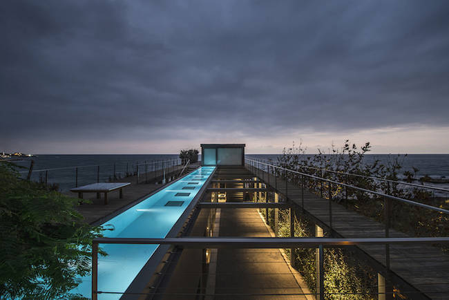 The home's unique design includes a long deck with an infinity pool.