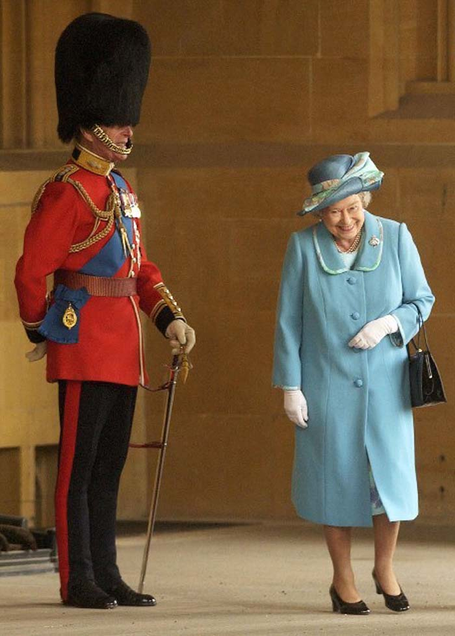 10.) The Queen of England laughing at her husband dressed in his ceremonial uniform.