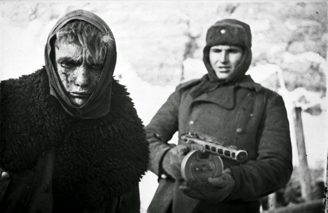 24.) German POW being escorted after the Soviet victory in Stalingrad.