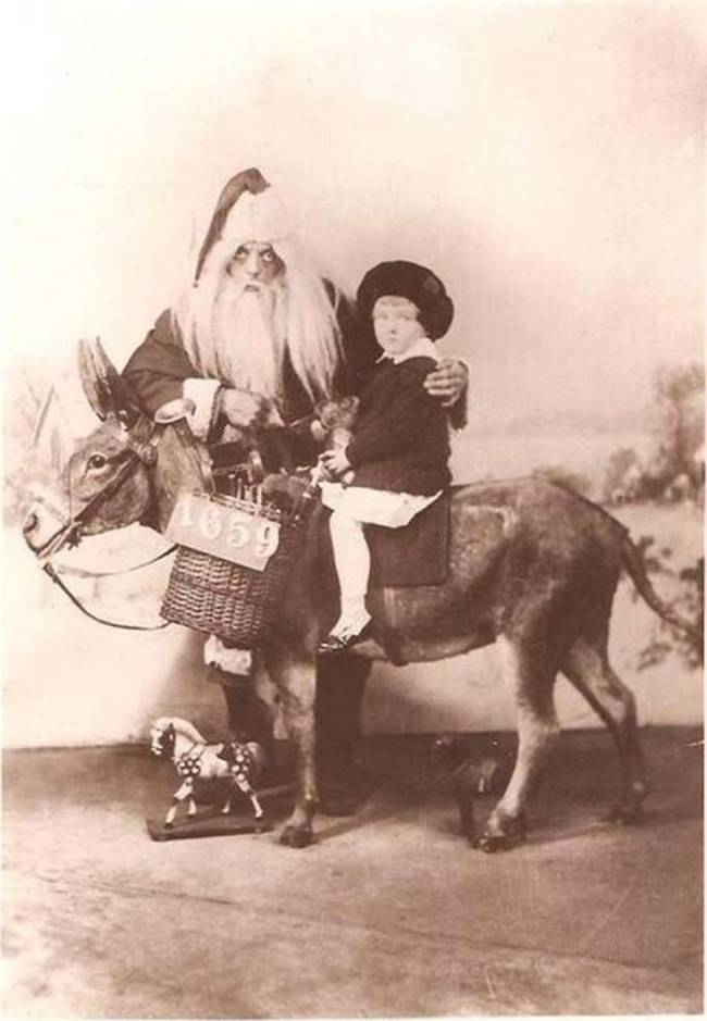 Why is Santa putting small children on a donkey?