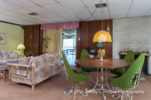 The family room (there's another, more formal living room elsewhere) has a laid-back, beachy vibe to it, and those green chairs help.