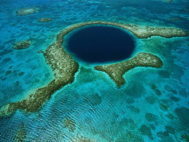 This stunning sinkhole is known as the Great Blue Hole. It can be found in Belize. Sinkholes can open up underwater, too. This one was formed by glaciers over 100,000 years ago.