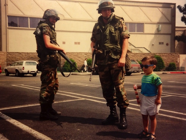 6.) During the 1992 riots in Los Angles, a young child poses with National Guard troops.