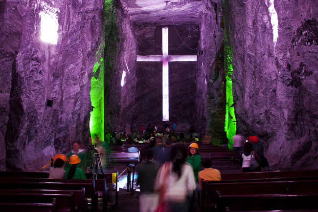 The church is lit by color-shifting lights that make the translucent halite walls glow. Visitors often wear hardhats just in case.