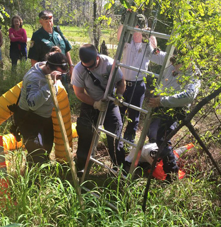 Once nothing hazardous was detected, they climbed down the hole on a ladder.