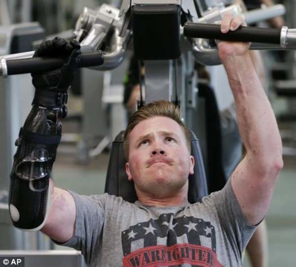 Brian Meyer works out using his prosthetic arm and two remaining fingers on his left hand at the Wounded Warrior Hope and Care Center in Camp Pendleton, California.