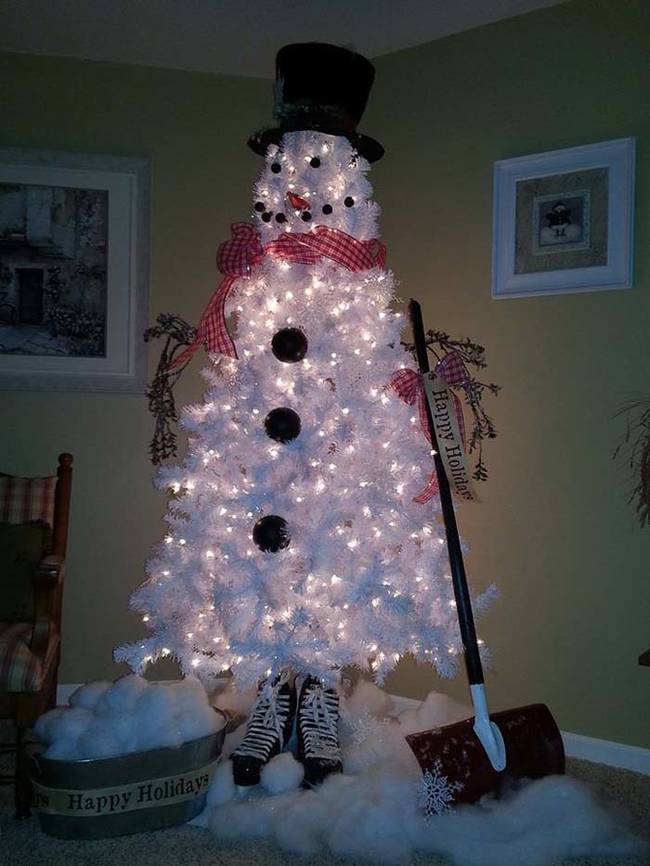 A store-bought, white Christmas tree can be turned into a snowman with a scarf, hat, and black felt.