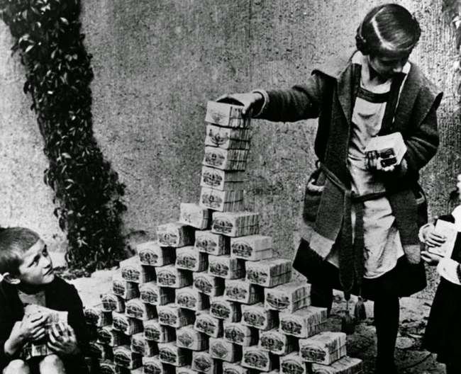 1.) German children play with stacks of money during the hyperinflation period of the Weimar Republic, 1922.