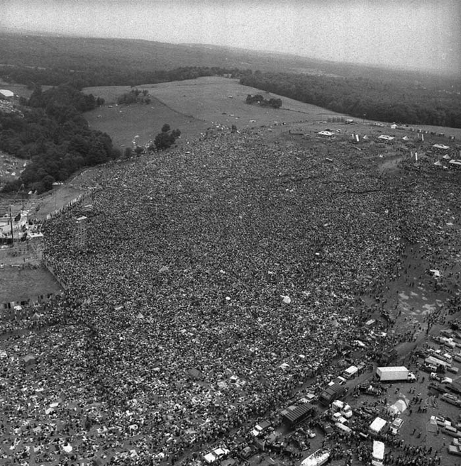 17.) 1969 - Crowds at the original Woodstock Music Festival.