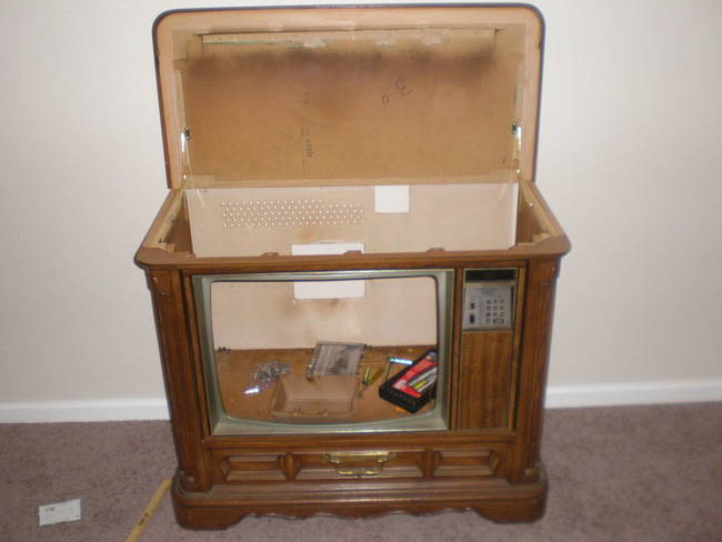 Next up, he had to install hinges on top of the TV to allow easy access to the fish tank once installed.