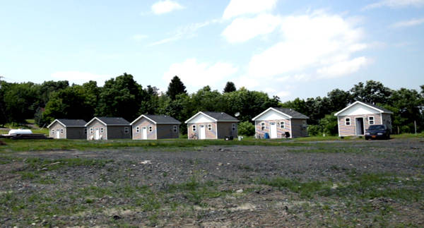 More efficient housing means less costly housing - and this has inspired some to use this type of housing to help the homeless get a new start in homes of their own. Below is a group of houses built for the homeless in Ithaca, New York.