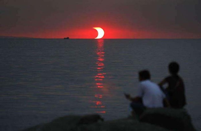 32.) An eclipse and a sunset, occurring at the same time.