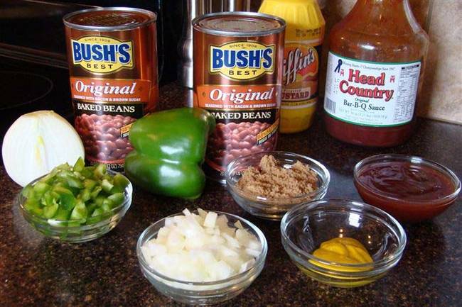 Make canned baked beans taste like a pit master's creation with barbecue sauce, peppers, onions and mustard. Head to <a href="https://ourtreasuredhome.blogspot.ca/2010/05/best-baked-beans.html">Our Treasured Home</a> for more tips.