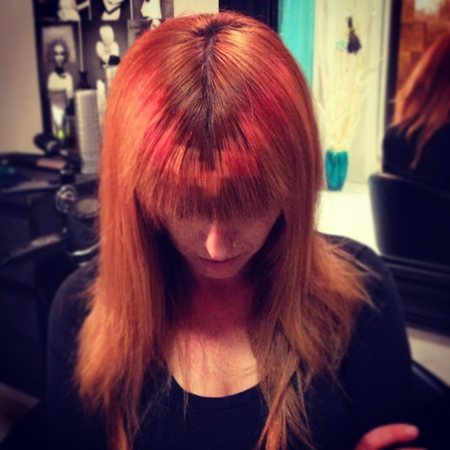 This design comes to a V at the center of the bangs, and the pink color against the red hair looks like a subtle glow.