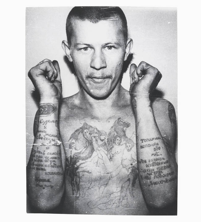 Sometimes tattoos were less symbolic and more literal, like this man's. The text on his forearms is a statement about his life as a prisoner. The right arm reads, "The court only deprived me of freedom, but nobody deprived me of human feelings. And the years go by, and my temples have gone grey, and my youth has been damaged." The left says, "Comrades, think of me every now and then. When the law sentenced me, in desolate camps of the taiga, I lived under the name of ‘prisoner.'"