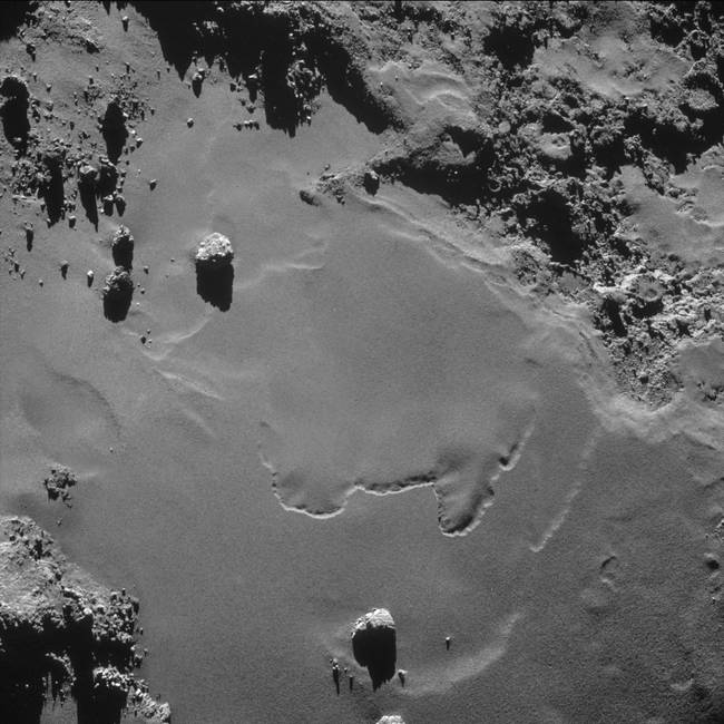 Comet 67P's sandy surface. The photos, which are taken in black and white, have been grayscaled to make the features more easily visible.