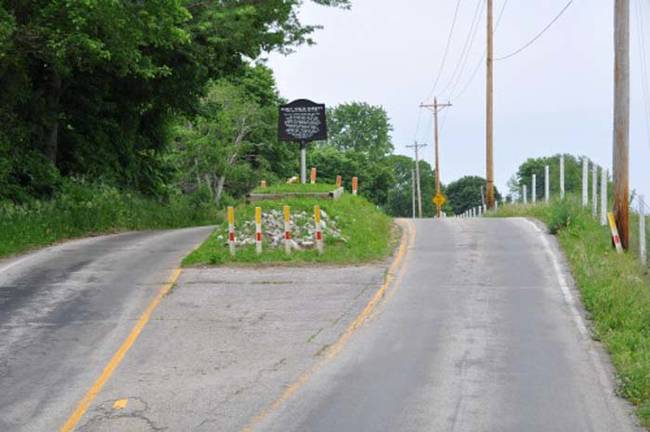 23.) This is the last remaining grave from an old cemetery in rural Indiana. Most of the graveyard was moved to make way for the state highway. The grandson of the woman buried there refused to have his grandmother moved. The county eventually gave in and built the road around the grave.