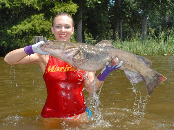 They wait for it to bite. When it does, they pull the fish up to the surface triumphantly with their hand still in its mouth.