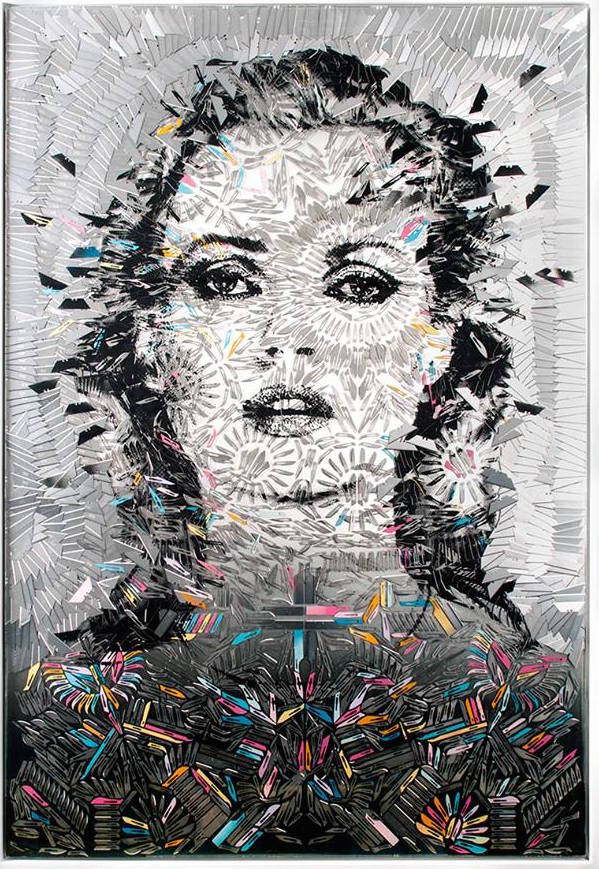 The portrait of a staring woman is decorated with ornate and complex patterns made of razor blades of varying colors and shades.
