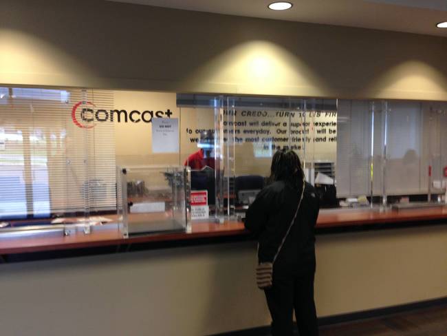 9) If you're looking for a sign that Comcast makes people happy, look no further than their office... where they greet your concerns through a cheerful window of bulletproof glass.