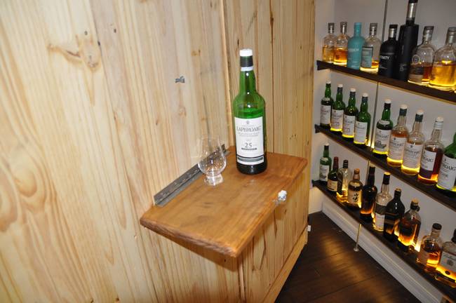 He even installed a little fold-out table where he can pour a few fingers of some of the finest whiskey in the world.