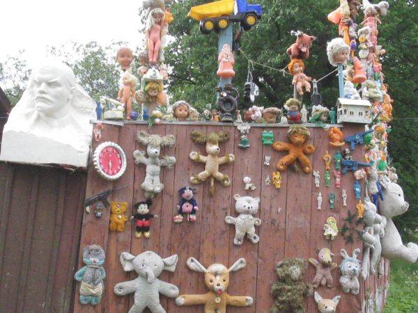 The faces of the dolls and stuffed animals nailed to the side of a shed stare back at you as the silence grows heavier. Their eyes seem to be watching you. But that can't be, right?