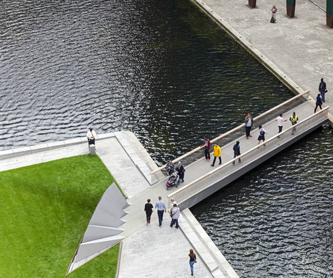 The wedge-shaped, raised pieces on the left side of the bridge (next to the grass) are part of the 40-ton counterweight that helps balance the beams and reduce the energy needed to lift them.