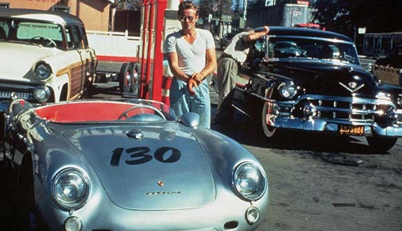 14.) James Dean stands with his allegedly haunted Porsche, which he only owned for 9 days, before his death. Many blame the car, “Little Bastard.”