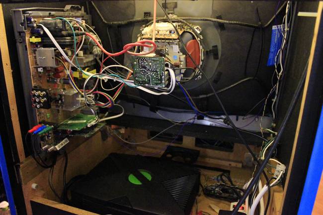 Here's all the important guts of the build, up and running. The circuit boards are Xbox controllers with wires soldered to them for hooking up the arcade buttons.