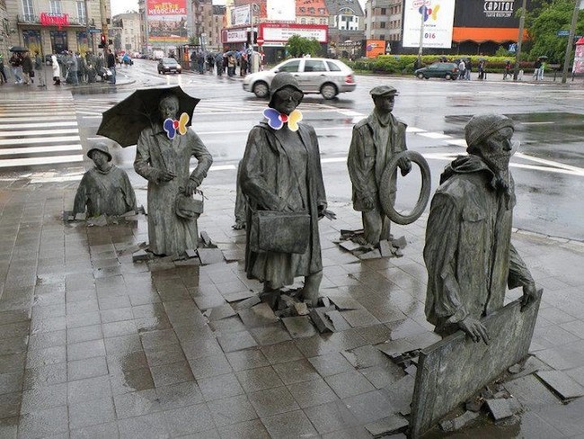 Who can say whether these statues of older folks are emerging out of the sidewalk or moonwalking back into it?