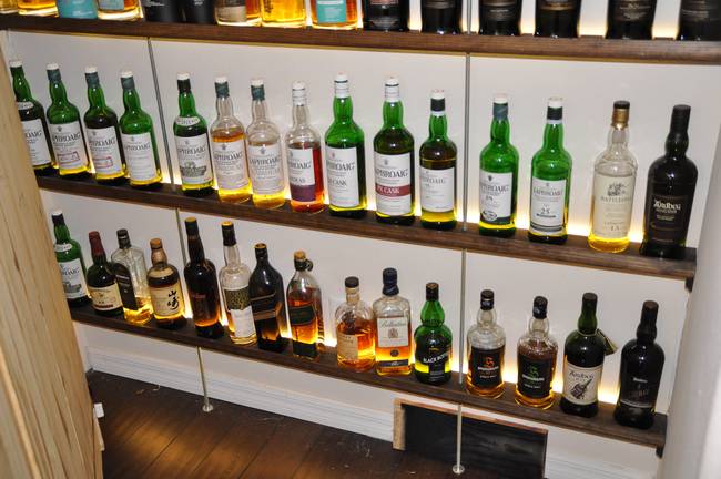 He's got six shelves full of amazing scotch - and they're definitely not the kinds you share with just <em>anyone</em> (which might also be why he built this awesome hiding place for his stash).