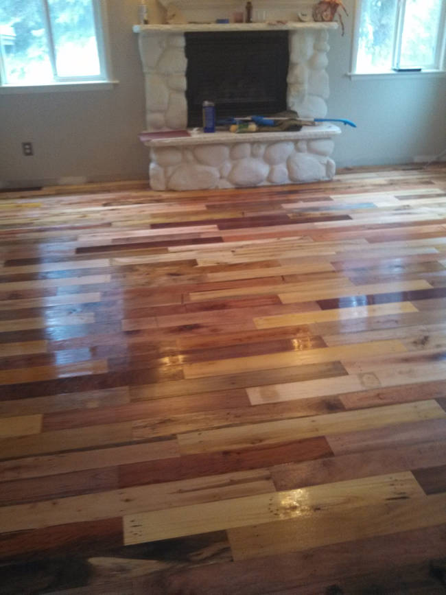 After sanding, nailing the floorboards into place, and finishing the wood, the rooms looked incredible with all the mixed colors.